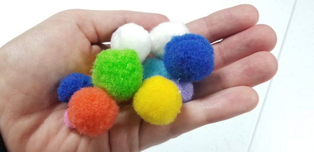 handful of pom pom balls craft