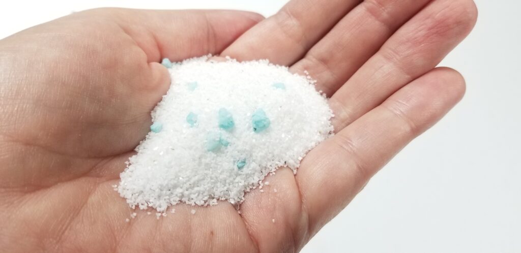 handful of white sand and rocks